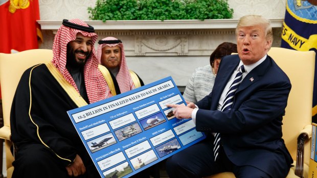 President Donald Trump shows a chart highlighting arms sales to Saudi Arabia during a meeting with Saudi Crown Prince Mohammed bin Salman in the Oval Office in 2018.