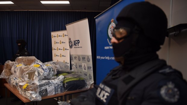 AFP officers stand guard over some of the 500 kilograms of cocaine seized during the Christmas Day bust in NSW.