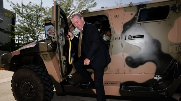 Then minister for defence industry Christopher Pyne steps out of a Hawkei vehicle in January.