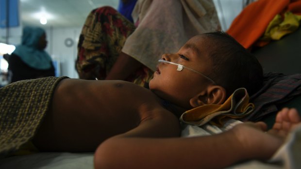 Jomil aged 2 lays unconscious whilst being treated for fever and breathing problems at the Medecins Sans Frontieres hospital in Kutupalong Camp. Kutupalong & Balukhali camps combined are the worlds largest refugee camp, home to approximately 400,000 of the 900,000 Rohingya who fled Myanmar.