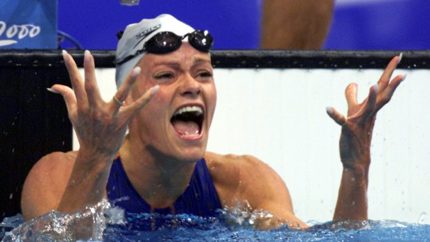 Dutch swimmer Inge de Bruijn celebrates after winning the gold medal in the women's 100m butterfly.