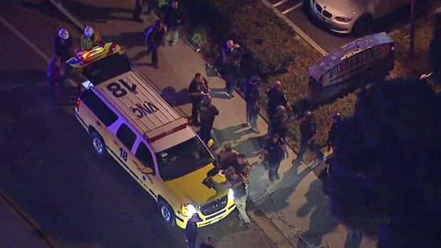 Officers around a Police SUV in the vicinity of a shooting in Thousand Oaks, California.