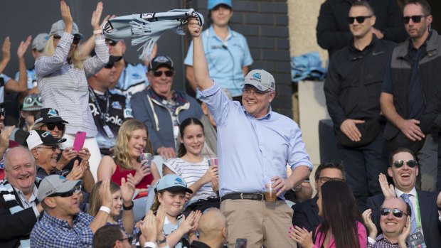 Prime Minister Scott Morrison waves to the crowd during the Round 10 NRL match between the Cronulla Sharks and the Manly Sea Eagles in 2019.