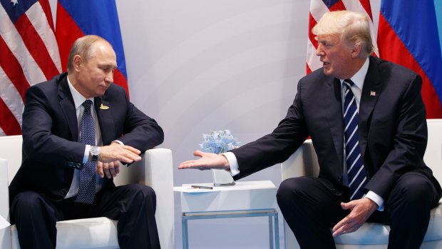 President Donald Trump reaches to shakes hands with Russian President Vladimir Putin at the 2017 G20 summit.