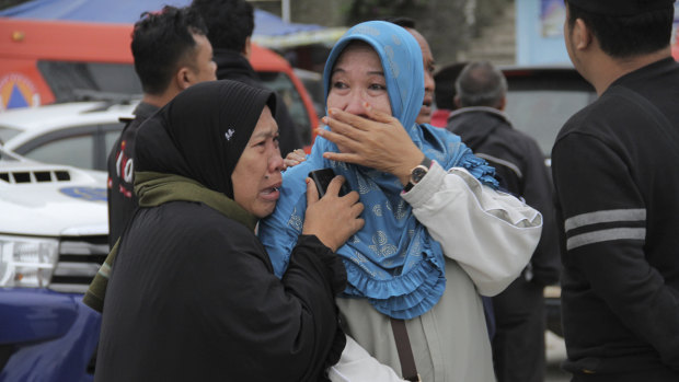Relatives weep at Tigaras port after learning that their family members were among the passengers on the ferry that sank on Monday.