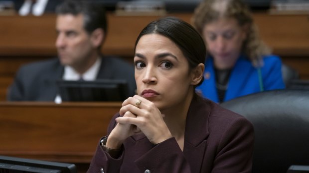 Alexandria Ocasio-Cortez listens to questioning of Michael Cohen, President Donald Trump's former personal lawyer.