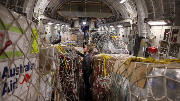 Former Foreign Affairs minister Julie Bishop inspects Australian aid supplies onboard a C17 bound for Vanuatu in 2015. A 2018 survey showed many Australians vastly overestimate the amount of aid Australia sends overseas.