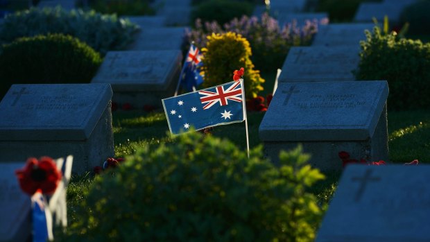 The last rays of the sun lights an Australian flag which has been placed on a grave at Lone pine in Gallipoli.