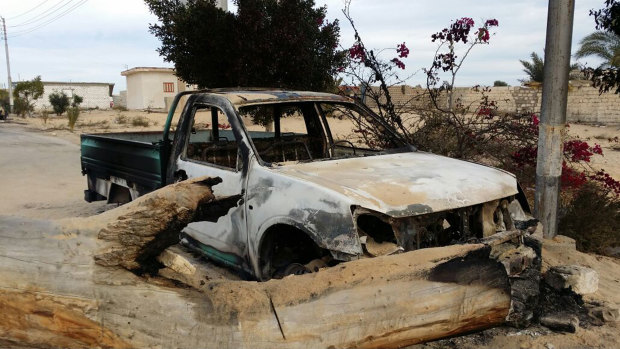 A burned truck is seen outside al-Rawda Mosque in Sinai, Egypt a day after attackers killed hundreds of worshippers in November, 2017.