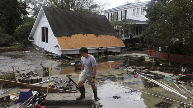 Resident Joseph Eudi looks at flood debris and storm damage from hurricane Florence at a home on East Front Street in New Bern, North Carolina on Saturday.