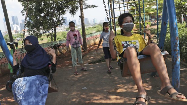 Children wear face masks as a precaution against the spread of coronavirus in Jakarta, Indonesia. 