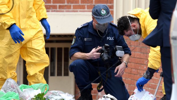 Police examine items outside Khaled Khayat's Lakemba unit as part of their investigation into an alleged terrorism plot.