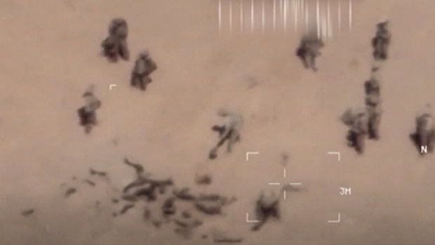 Aerial surveillance taken by the French military early Thursday and provided to The Associated Press show what appear to be 10 Caucasian soldiers covering approximately a dozen Malian bodies with sand near the Gossi military base, according to a French military officer.