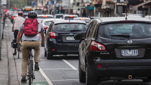 Cyclists navigate busy traffic.