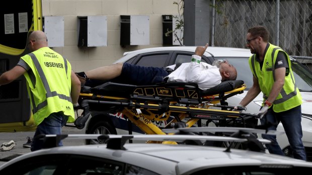 Ambulance staff take a man from outside a mosque in central Christchurch, New Zealand, Friday.