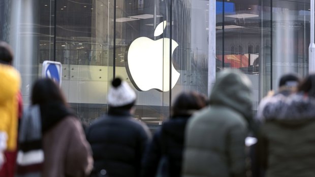 Pedestrians walk past the Apple store at Wangfujing in Beijing, China, on January 3. Apple cut its revenue outlook for the first time in almost two decades citing weaker demand in China.