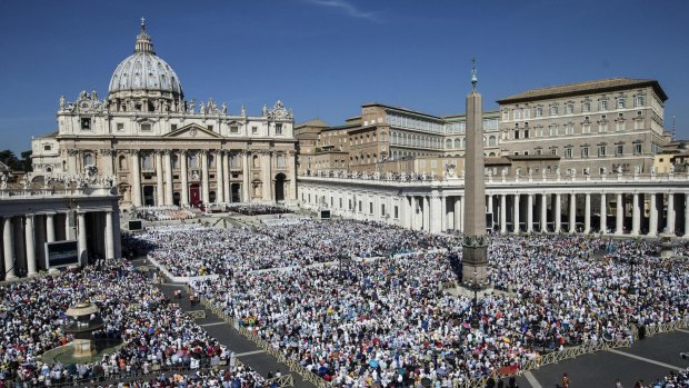 St Peter's Square is crowded with thousands of faithful attending a canonisation mass by Pope Francis.