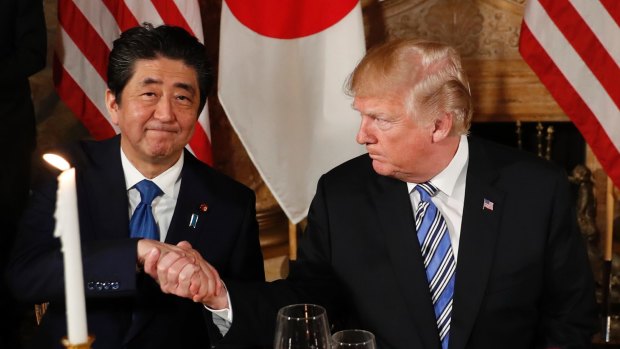 US President Donald Trump shakes hands with Japanese Prime Minister Shinzo Abe before dinner at Trump's Mar-a-Lago club last week.
