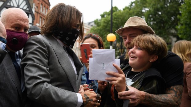 Actor Johnny Depp speaks to supporters and well-wishers as he arrives at the Royal Courts of Justice.