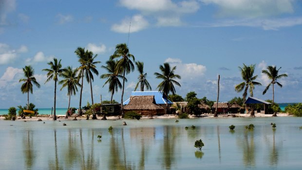 Flooded homes in the village of Taborio on the Tarawa atoll in Kiribati