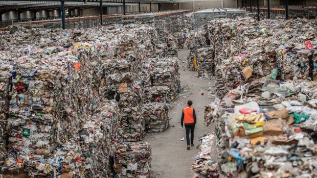 A warehouse stacked to the rafters bales of recycling waste brought here from Adelaide and other places by SKM. 14th August 2019. Photo by Jason South