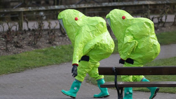 Personnel in hazmat suits walk away in Salisbury, England, after former Russian double agent Sergei Skripal and his daughter Yulia were found critically ill by exposure to a nerve agent.