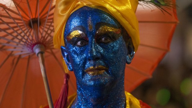 A reveller takes part in the Mardi Gras parade.