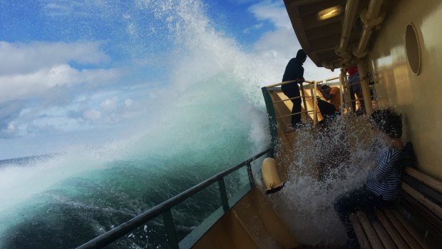 Tourists are soaked on a Manly ferry during a heavy swell.