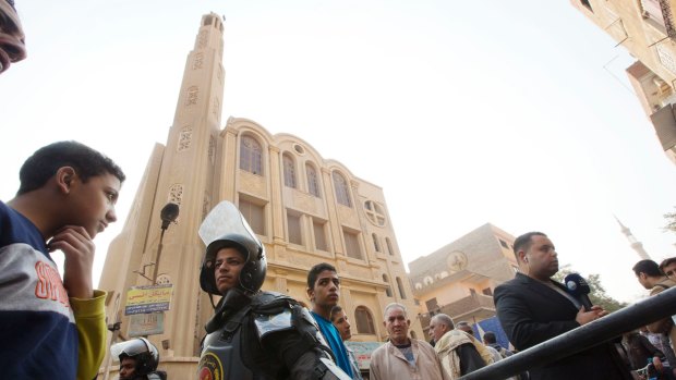 Policemen surround Mar Mina church, in Helwan, Cairo, Egypt, where at least 10 people, including eight Coptic Christians, have been killed in a shootout outside the church. 
