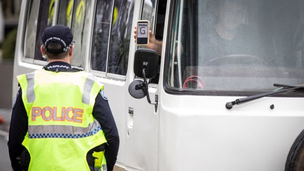 Police check cars for permits at a checkpoint in Coolangatta on Friday.