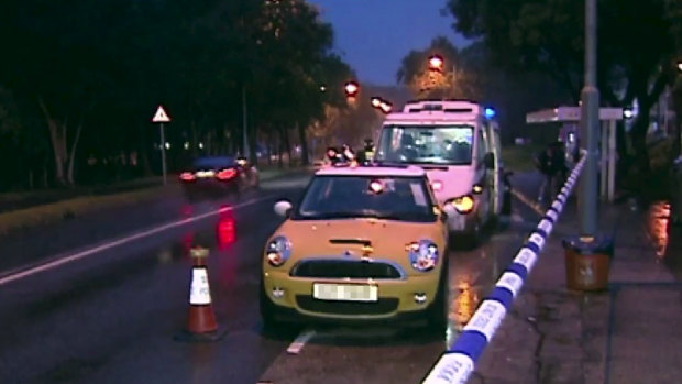 The yellow mini cooper where the suspect's wife and daughter were found unconscious in Hong Kong.