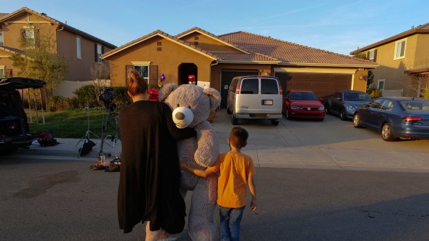 A neighbour leaves a gift for the children outside the so-called 'house of horrors'.