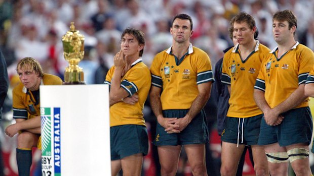 Phil Waugh (left) and former league star Mat Rogers (second from left) watch on as England claim the Rugby World Cup in 2003.