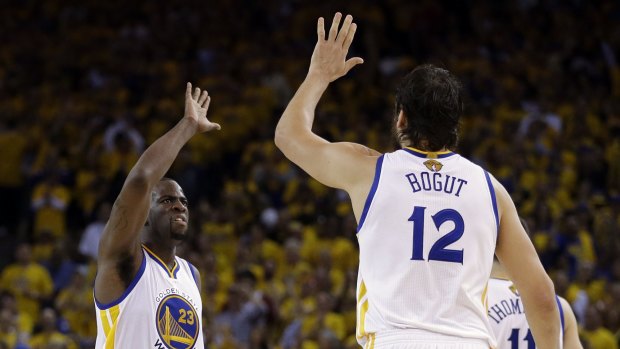 Opportunity: Andrew Bogut, seen here alongside Draymond Green in the 2015 NBA Finals, is poised to rejoin the Warriors.