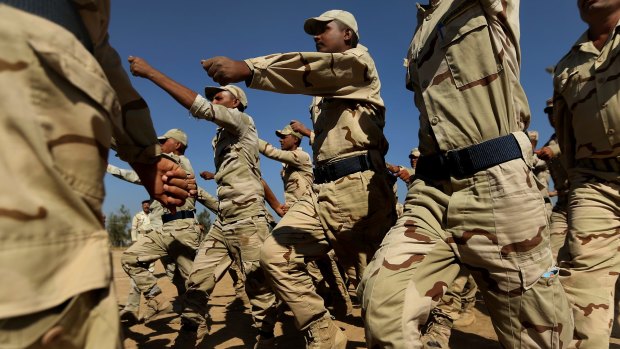 Iraq army recruits, pictured training in Baghdad, will benefit from a small increase in Australian involvement aimed at deterring Islamic State.