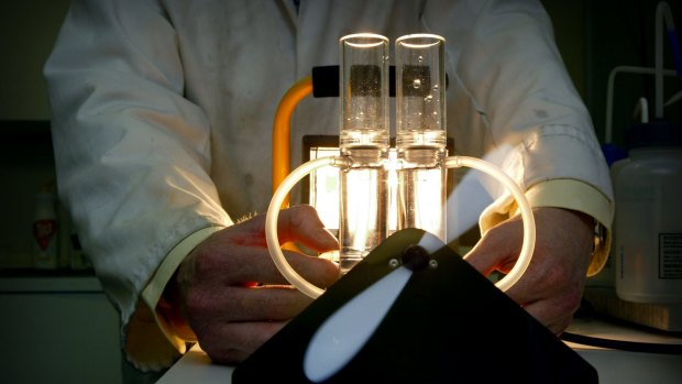 A scientist demonstrates technology that produces hydrogen fuel from solar power.