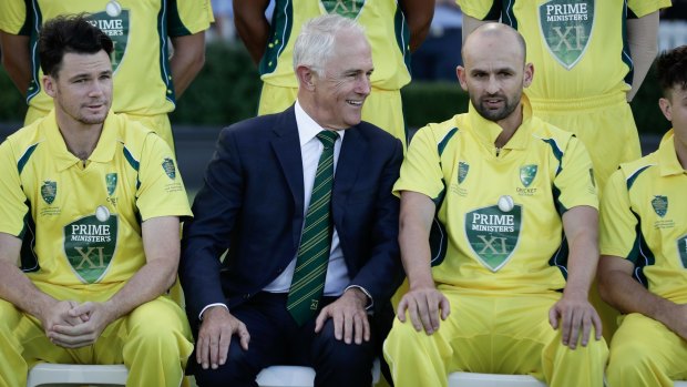 Prime Minister Malcolm Turnbull speaks with captain Nathan Lyon during a team ahead of the PM's XI cricket match against England earlier this year.