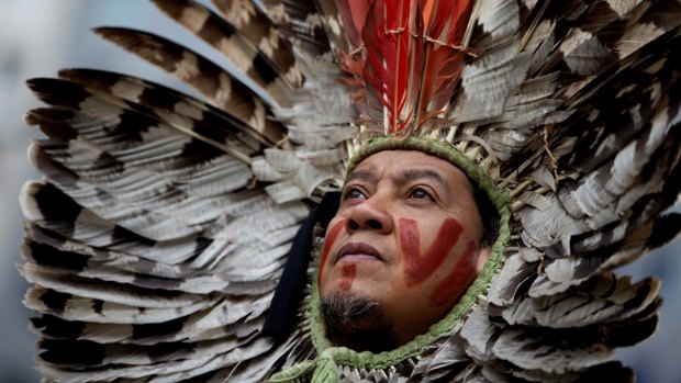 A leader of an indigenous community in Brazil protests forest destruction in Brussels last year. Activists say indigenous people across the Amazon are the environment's last line of defence.