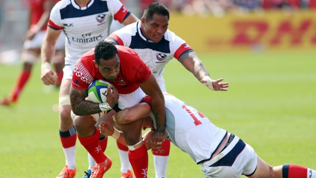 Fetu'u Vainikolo of Tonga is tackled by Brett Thomson of the USA during the World Rugby Pacific Nations Cup.