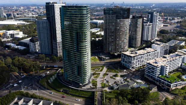 The evacuation of the Opal Tower, in the foreground, two years ago due to cracking led to a shake-up of building regulations.