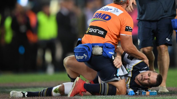 Horrible break: Shaun Fensom of the Cowboys lies injured on the pitch during the NRL grand final.