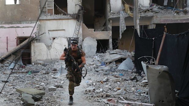 A US-backed Syrian Democratic Forces fighter during the battle to retake the former Islamic State capital of al-Raqqa in Syria.