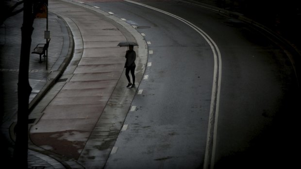 Umbrellas come out on the streets of Bondi Junction as light rain falls in Sydney.