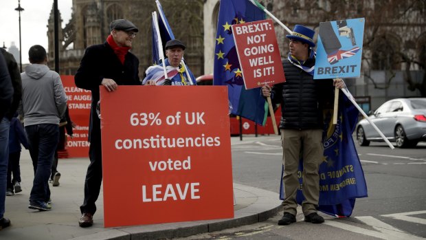 Pro- and anti-Brexit supporters protest outside the Houses of Parliament in London.