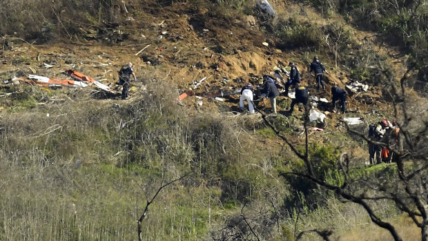 Investigators work the scene of a helicopter crash that killed former NBA basketball player Kobe Bryant, and his 13-year-old daughter, Gianna in Calabasas, California. 