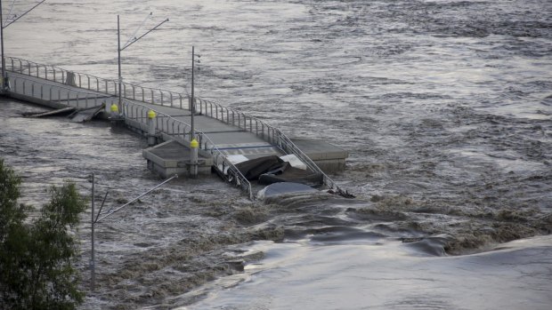 The New Farm Riverwalk floats down the Brisbane River during the 2011 floods.