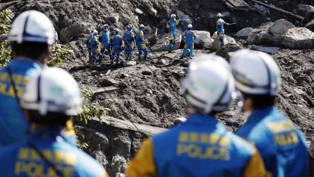 Rescuers search for missing persons at the site of a landslide in Marumori, near Fukushima.