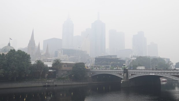 City buildings are seen through smoke haze from bushfires in Melbourne, Tuesday, January 14, 2020. 