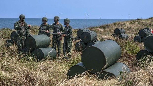 Soldiers set up barricades on a beach during a military exercise in Miaoli, Taiwan, last month.