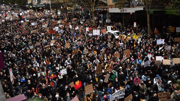 A sea of protesters marching down Bourke Street.